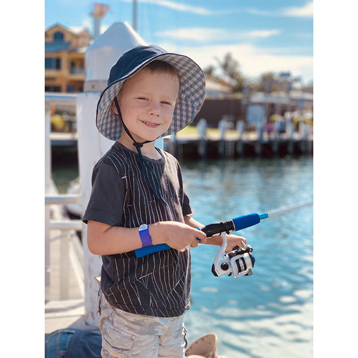 Boy fishing on a pier