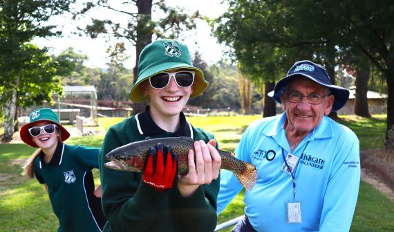 volunteer and kids with fish