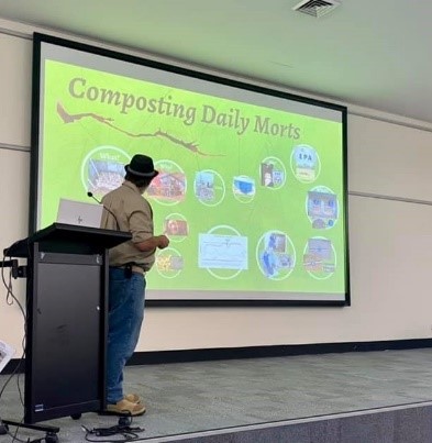 Man giving a presentation about composting daily mortalities