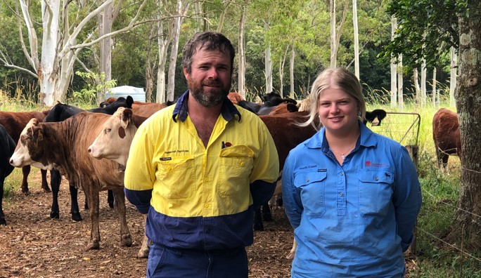 Emma Somerville with NSW DPI Wollongbar farm manager Michael Beaumont standing in front of a mob of cattle.