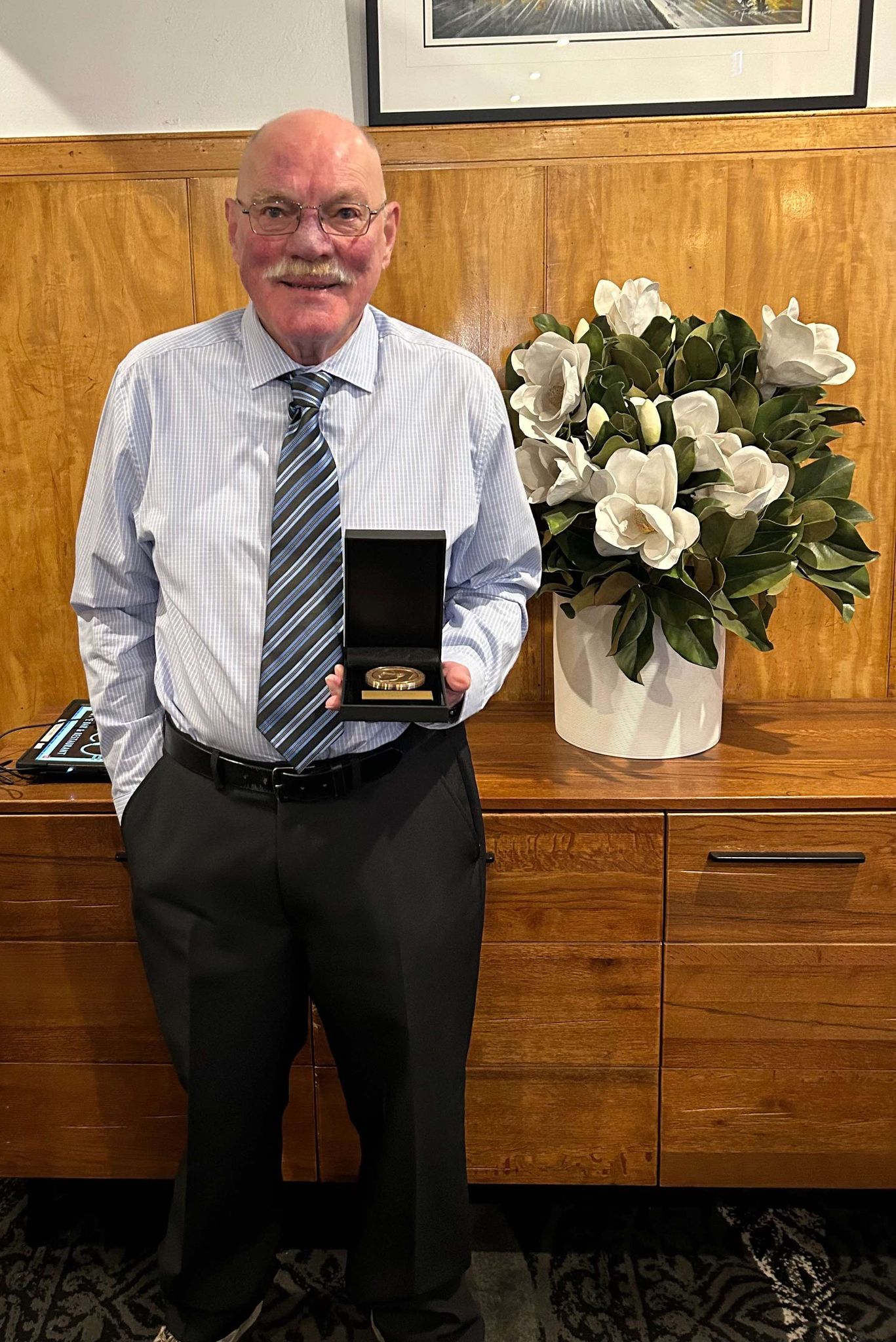 Dr Kevin Moore holding the 2023 Farrer Memorial Medal