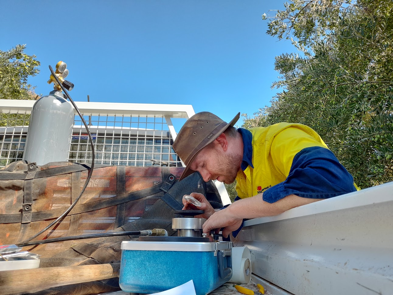 Alex Schultz checking stem water potential, this is done in conjunction with high resolution imagery taken by aircraft to corelate plant stress to imagery and also from plant and soil moisture sensors.