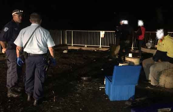 Fisheries Officers and NSW Police Officers apprehending fishers at Eraring Power Station hot water outlet closed waters