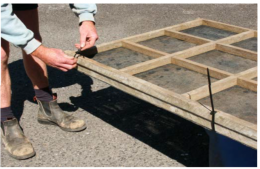 Spat bearing tray and lid tray being tied together through aligned holes drilled in the tray frames.