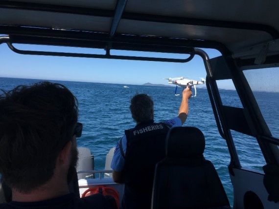 Fisheries Officer launching an un-manned aerial vehicle (UAV) from fisheries patrol vessel