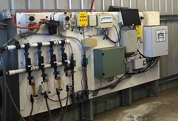direct injection unit inside farm shed showing electronics and equipment on wall