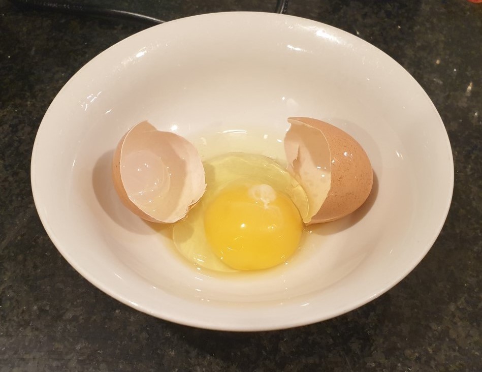 Cracked egg in a bowl