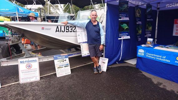Fisheries officer manning a display at a caravan show