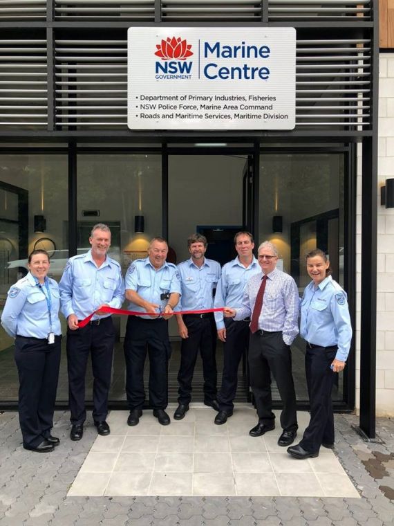 Fisheries officers cutting a ribbon for the opening of the new Tweed Marine Centre in Tweed Heads
