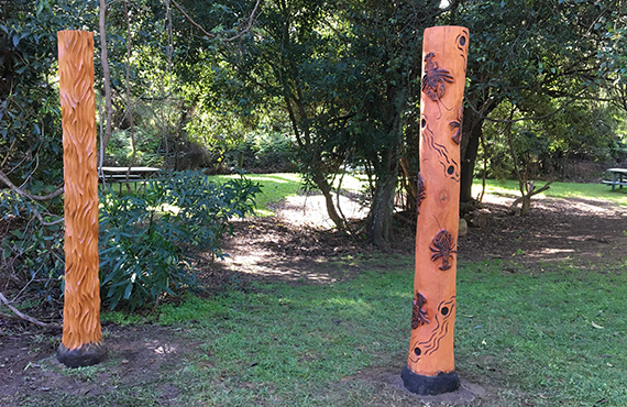 The two poles that local Aboriginal artist Noel Wellington has carved with designs representing the FFSC and the holes and water they call home