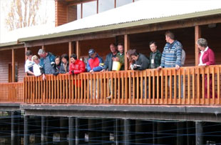 Visitors at the Visitor Centre viewing pond